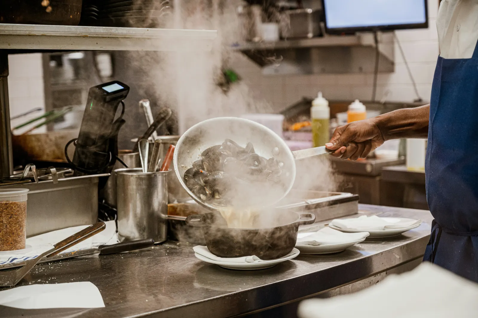 Cooks working the line in a busy restaurant kitchen during service
